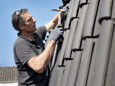 Industrial roofing crew inspecting a commercial roof in Connecticut